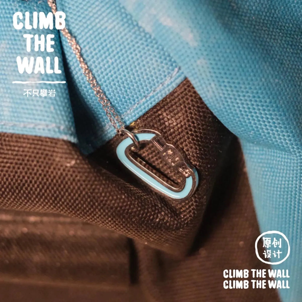 Close-up of a brown bag with a blue tag and 'CLIMB THE WALL' text on a blue background.