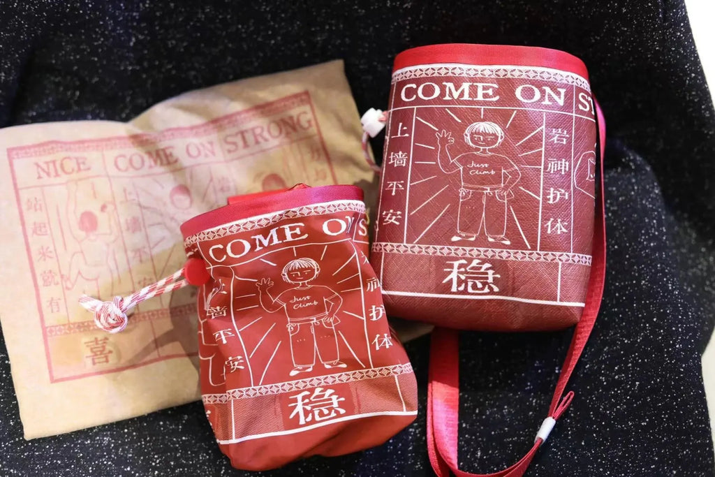 Red pouches with 'NICE, COME ON, STRONG' text and illustrations on a dark surface