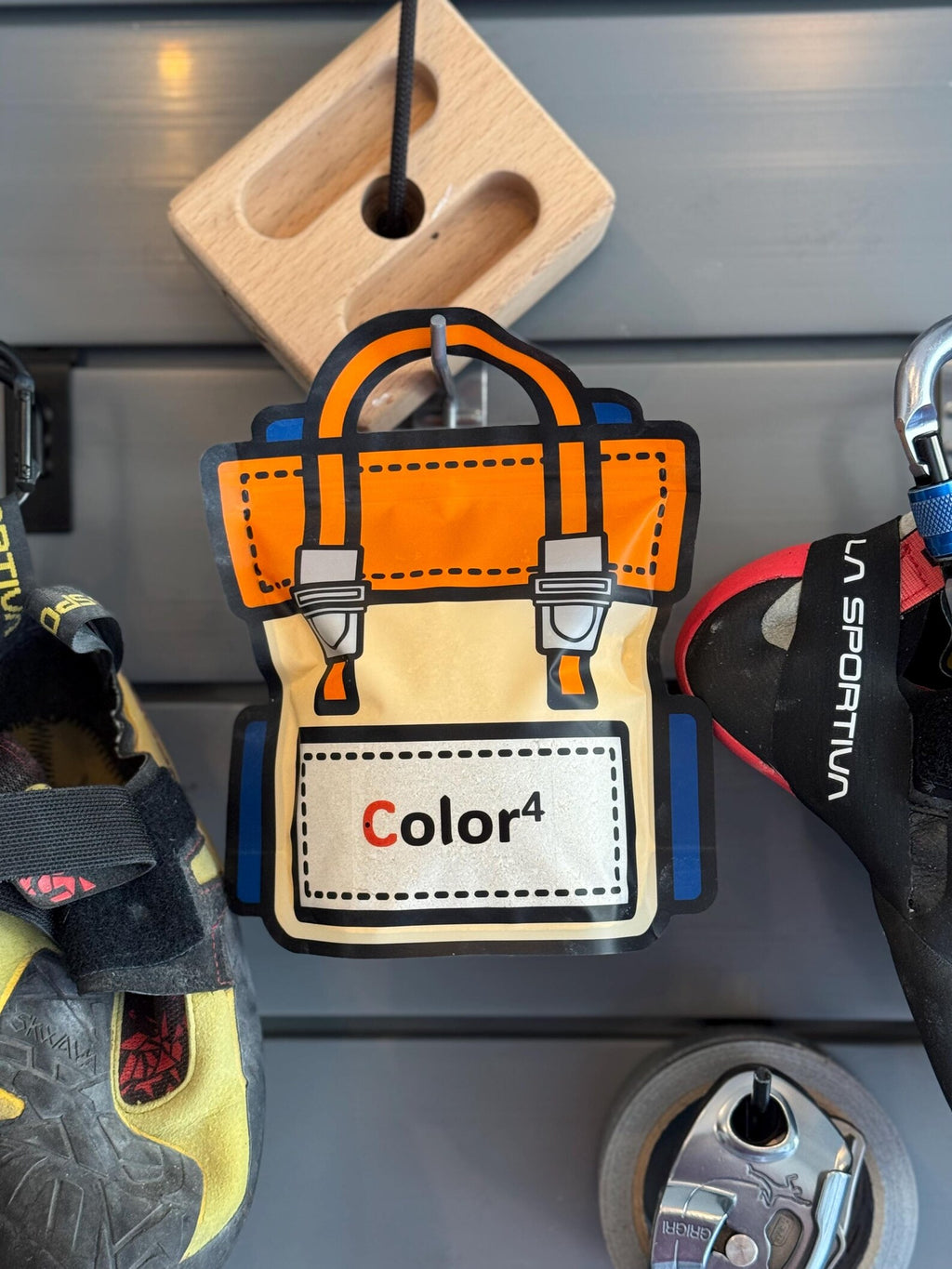 Color4 tool bag keychain on a metal surface with tools in the background
