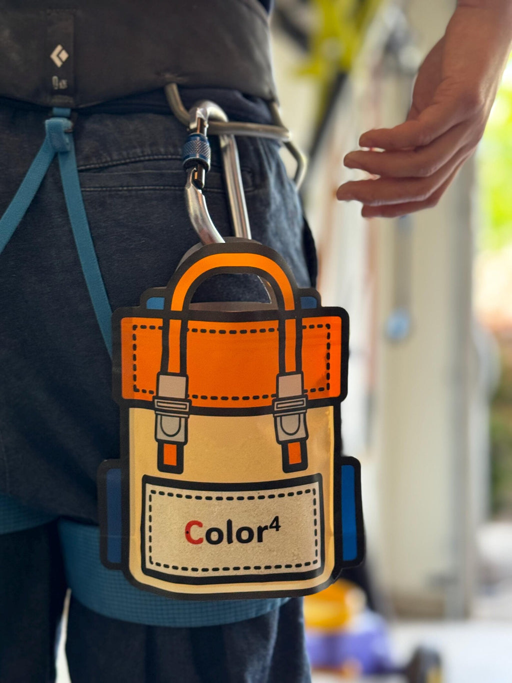 Orange and beige tool pouch with 'Color4' branding attached to a person's waist.